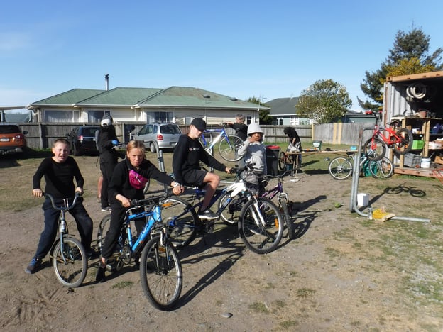 students fix bikes